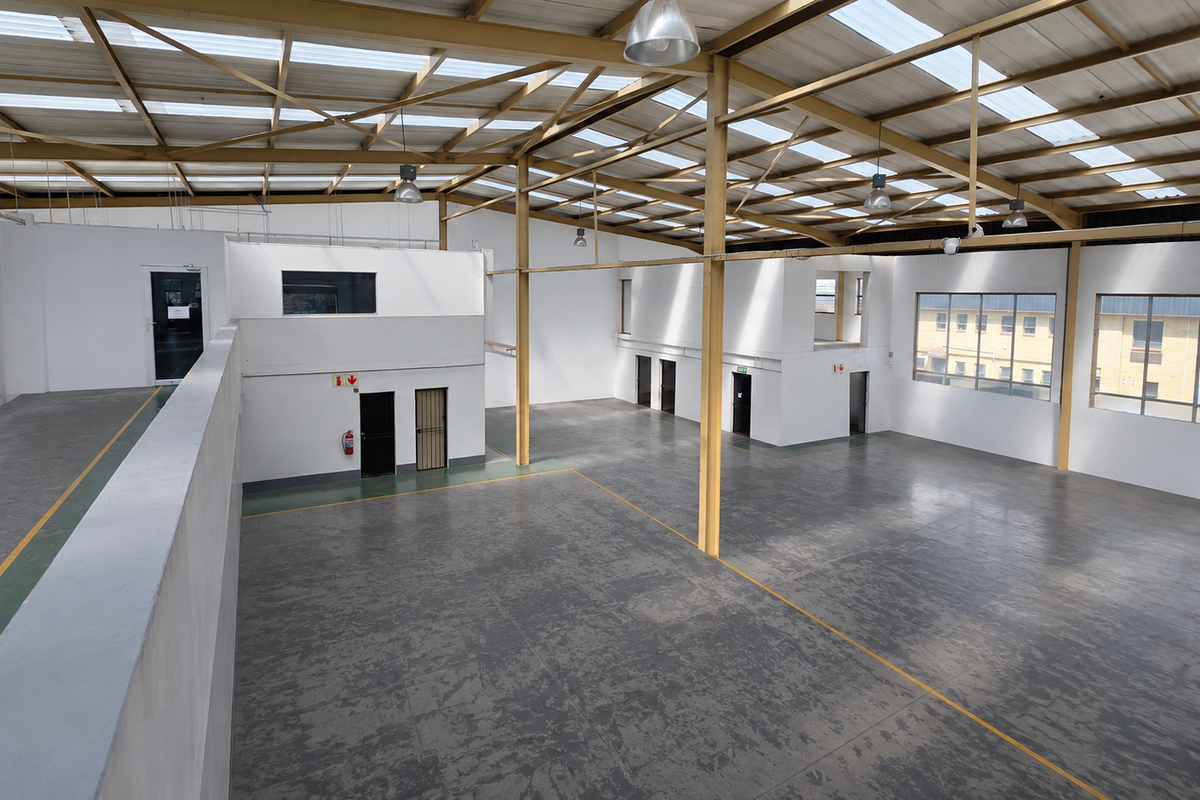 Spacious industrial warehouse featuring a high-clearance steel portal frame, translucent roof panels for natural light, epoxy flooring, and a mezzanine level.