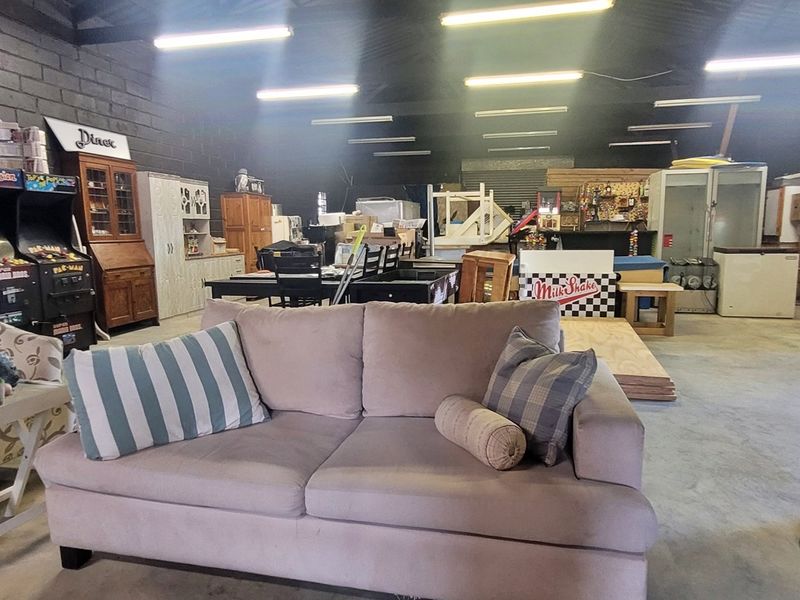 Spacious industrial open-plan area featuring exposed blockwork walls, concrete flooring, and high-output fluorescent lighting, suitable for versatile commercial or workshop use.