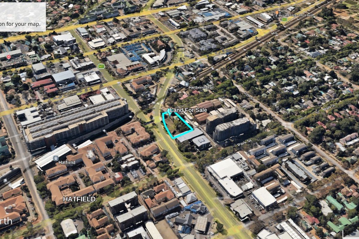 Aerial view of a vacant commercial land plot located in Hatfield, highlighting the property boundaries within the surrounding urban infrastructure.