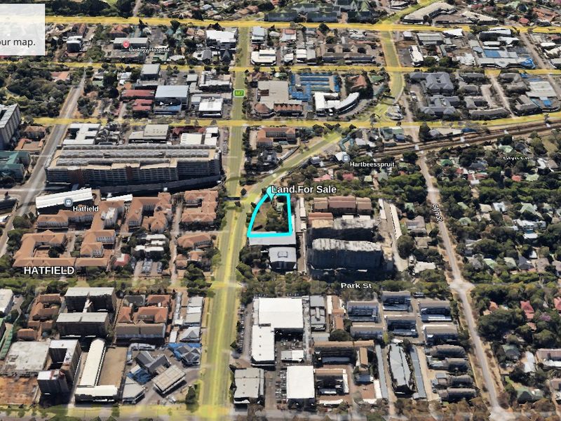 Aerial view of a vacant commercial land plot located in the Hatfield area, highlighting its position within the urban landscape.
