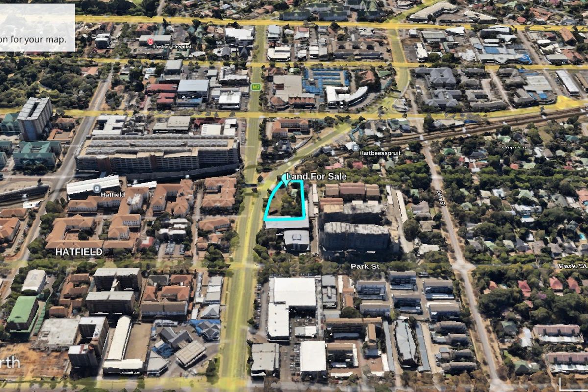 Aerial view of a vacant commercial land plot located in the Hatfield area, highlighting its position within the urban landscape.