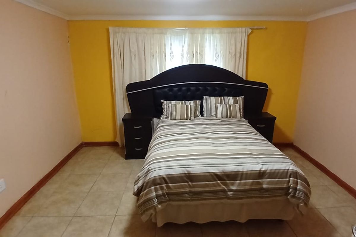 A bedroom featuring tiled flooring and a neutral layout, offering a functional space ready for personalization and cosmetic updates.