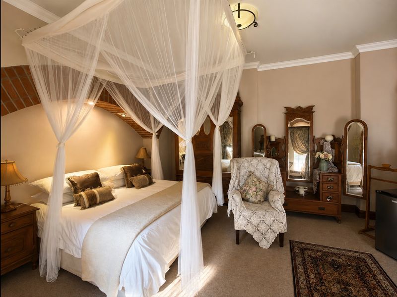 A well-maintained bedroom featuring a unique exposed brick archway, crown molding, and recessed lighting, creating a warm and inviting atmosphere.