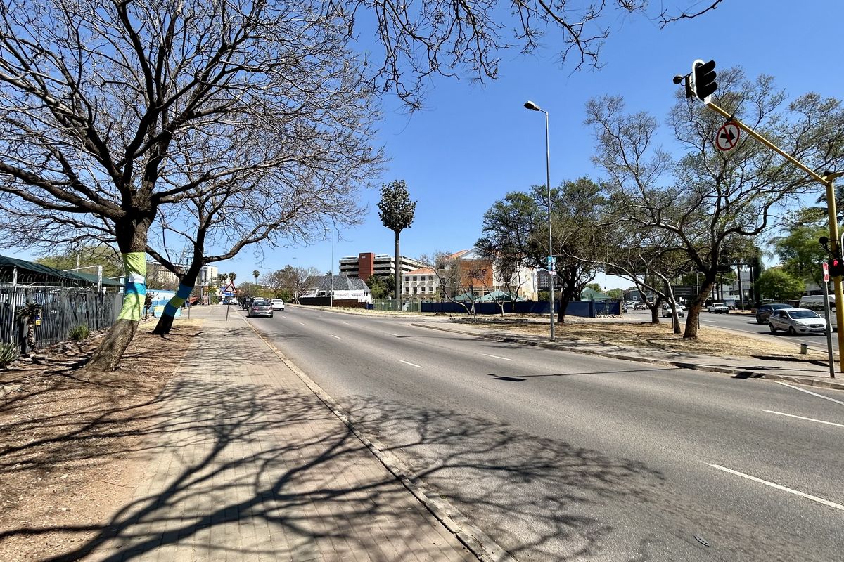 A clear street-level view of the public road and sidewalk infrastructure adjacent to the commercial property.