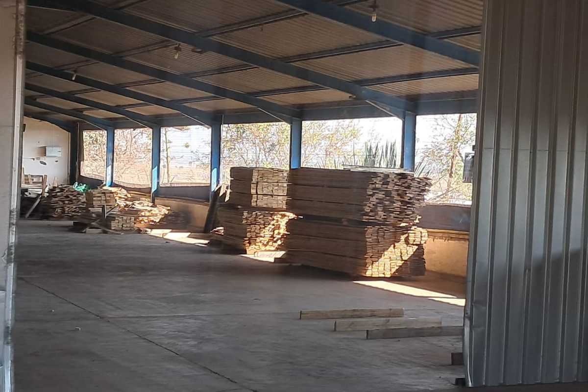 Spacious industrial utility area featuring a steel portal frame structure, corrugated metal roofing, and durable concrete flooring, suitable for storage or workshop use.