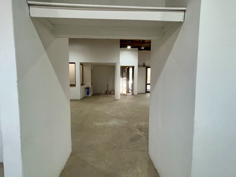 An open-plan retail space featuring concrete flooring and structural columns, offering a blank canvas for custom interior fit-outs.