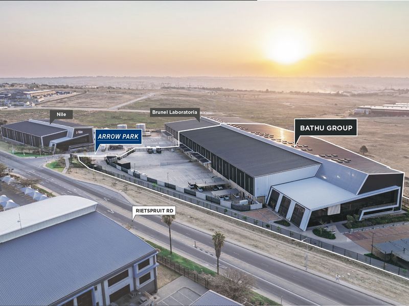 Aerial view of the Arrow Park industrial complex, featuring large warehouse facilities, paved yard space, and secure perimeter access.