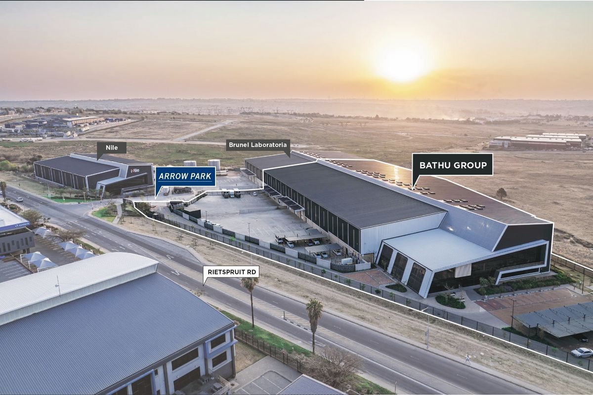 Aerial view of the Arrow Park industrial complex, featuring large warehouse facilities, paved yard space, and secure perimeter access.