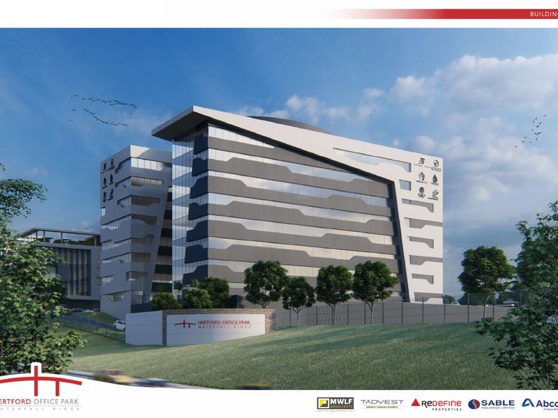 A modern multi-story office building featuring contemporary architectural design, glass curtain walls, and professional signage within a landscaped office park setting.