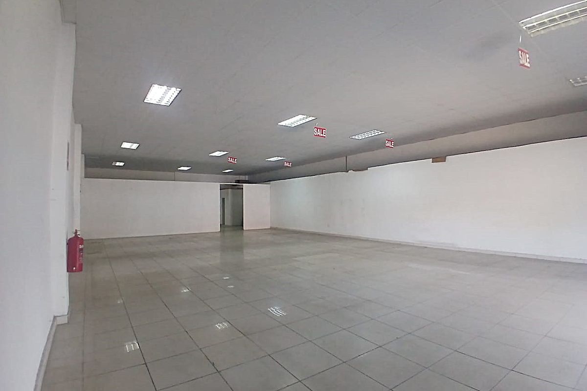 Spacious open-plan retail unit featuring tiled flooring, suspended ceilings with recessed lighting, and a clean, versatile layout suitable for various commercial business applications.