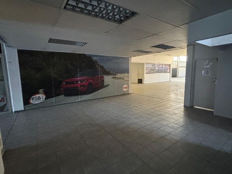 An open-plan retail or showroom space featuring tiled flooring, recessed ceiling lighting, and a neutral layout suitable for various commercial applications.