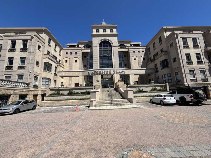 A professional exterior view of the Waterside Place office building, featuring a prominent stone staircase entrance, brick facade, and paved forecourt.