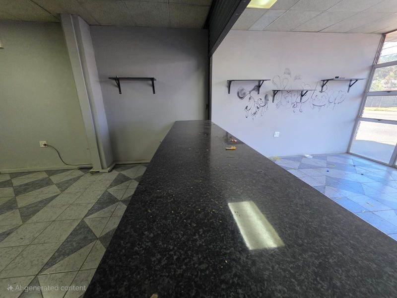 Empty retail space featuring a built-in counter, tiled flooring, and large storefront windows, requiring cosmetic updates and repairs to the walls and flooring.