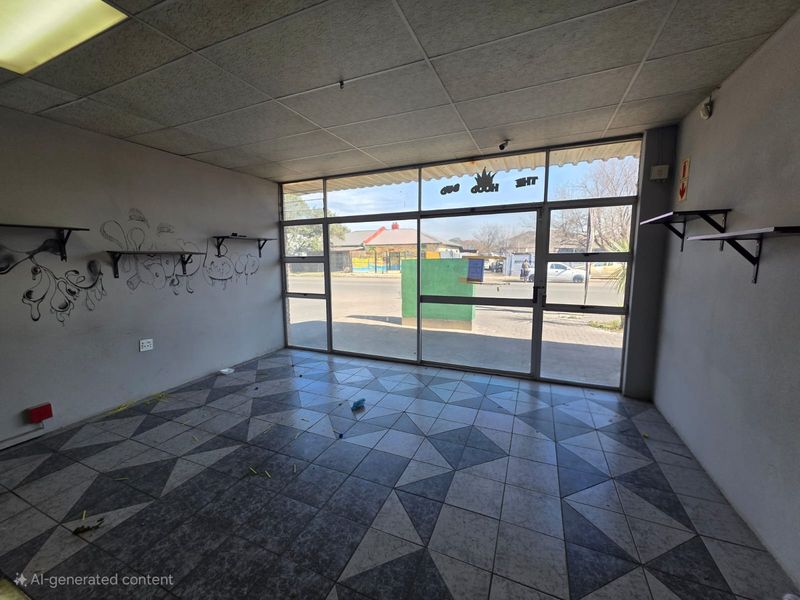 Vacant retail storefront featuring large glass display windows, tiled flooring, and a suspended ceiling, offering a blank canvas for commercial renovation.