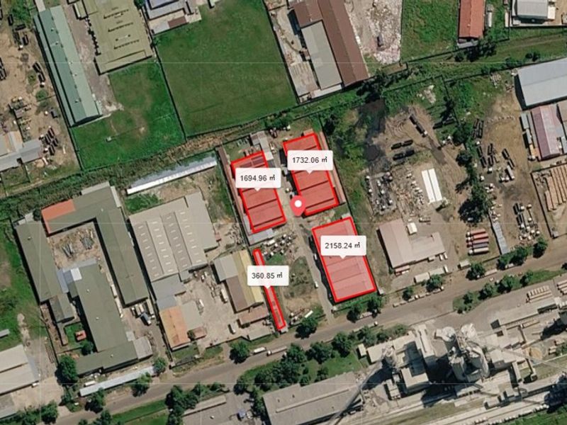 Aerial view of a commercial industrial site featuring multiple warehouse buildings with designated square footage measurements and surrounding yard space.