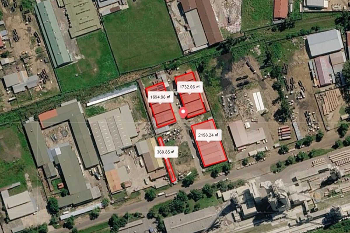 Aerial view of a commercial industrial site featuring multiple warehouse buildings with designated square footage measurements and surrounding yard space.