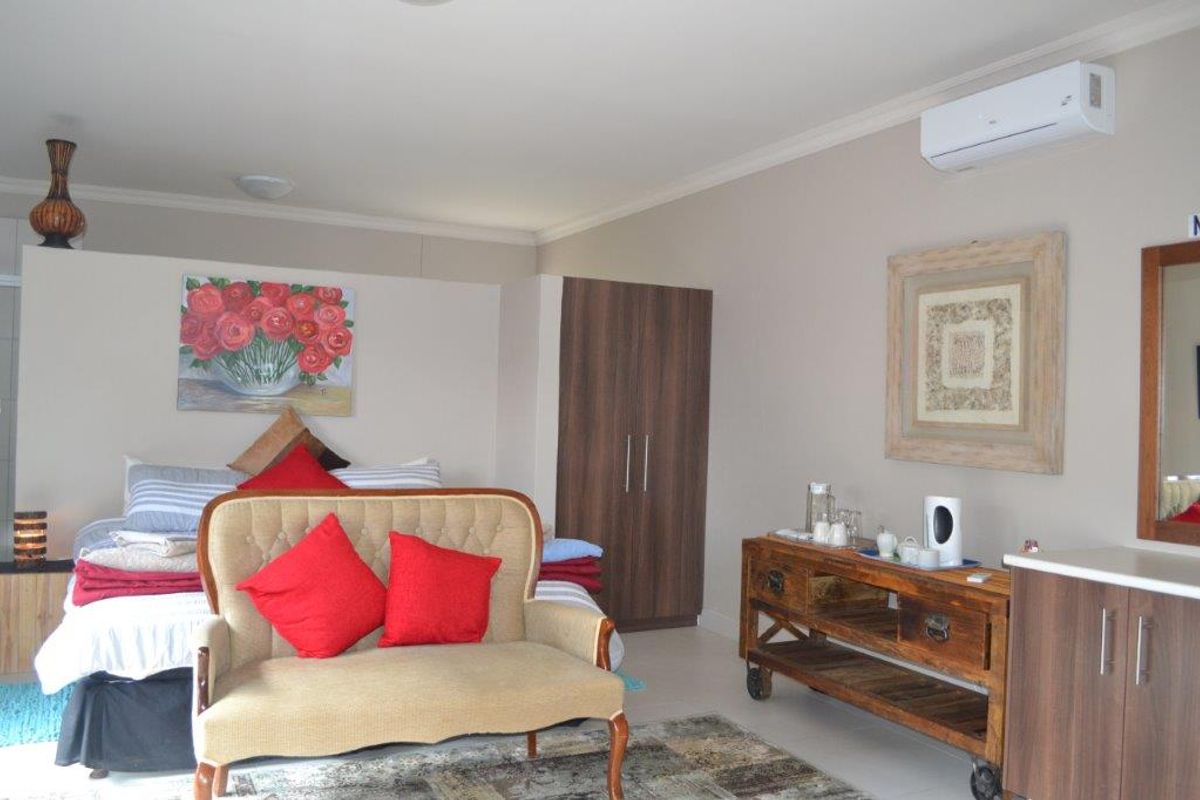 A well-maintained bedroom featuring a built-in wardrobe, split-system air conditioning, and neutral wall finishes.