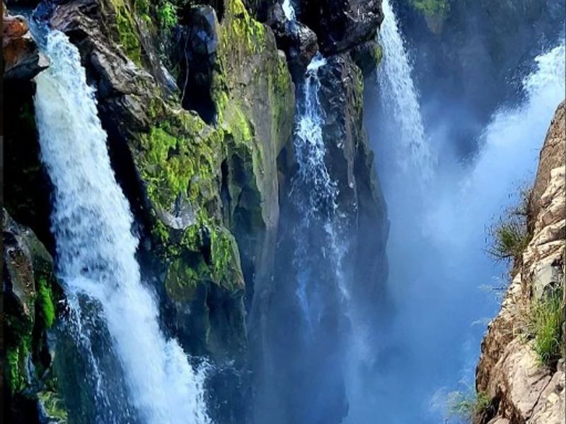 A scenic view of a natural waterfall cascading down a rocky cliff face.
