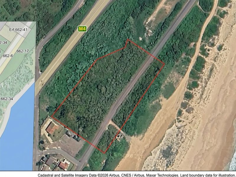 Aerial view of a vacant commercial land parcel situated near the coastline, featuring natural vegetation and proximity to major road infrastructure.