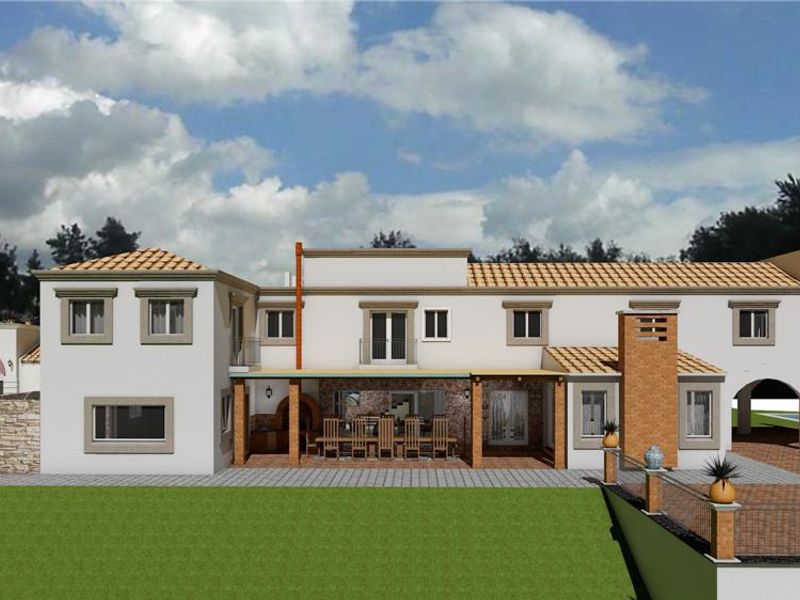 A 3D architectural rendering of the rear elevation of a large house, featuring a covered patio, balcony, and extensive brick-paved outdoor areas.