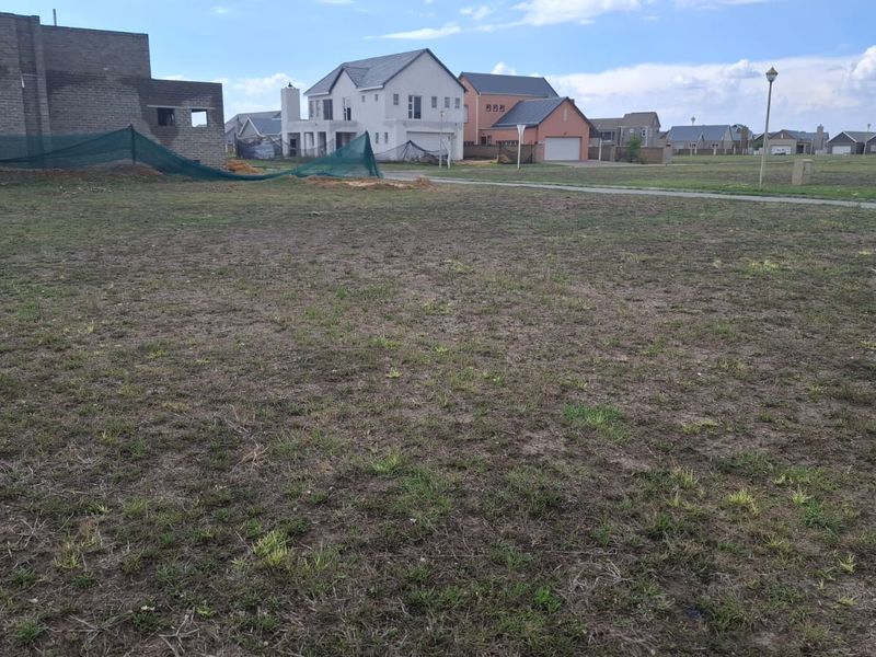 A vacant residential plot of land situated in a developed estate, offering a clear building site for a new home.