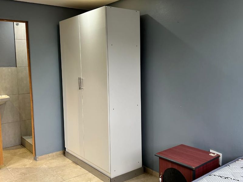 A bedroom featuring tiled flooring, recessed ceiling lights, and direct access to an en-suite bathroom.