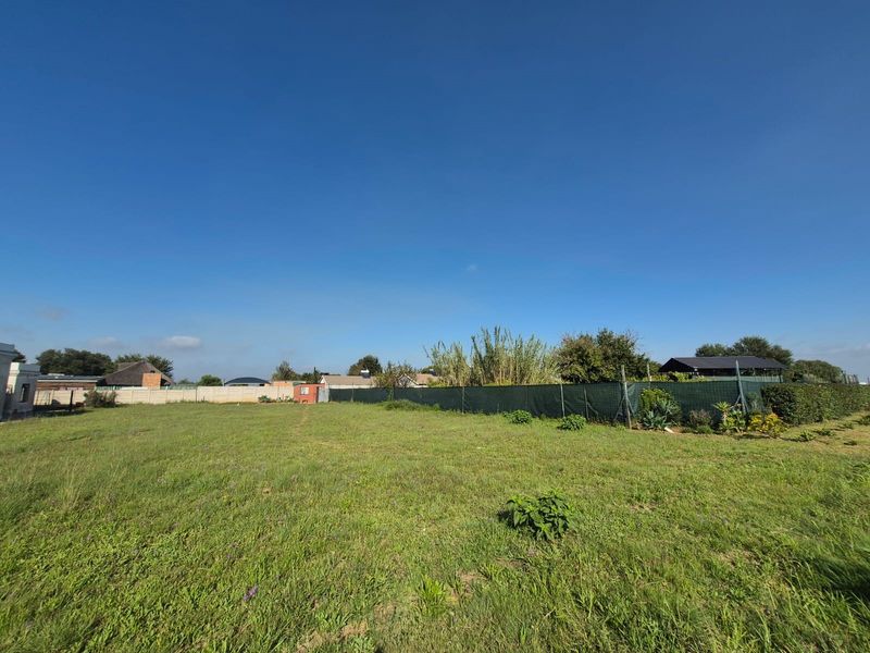 A spacious, level residential vacant land plot featuring established grass cover and perimeter fencing, offering a clear area for future development.