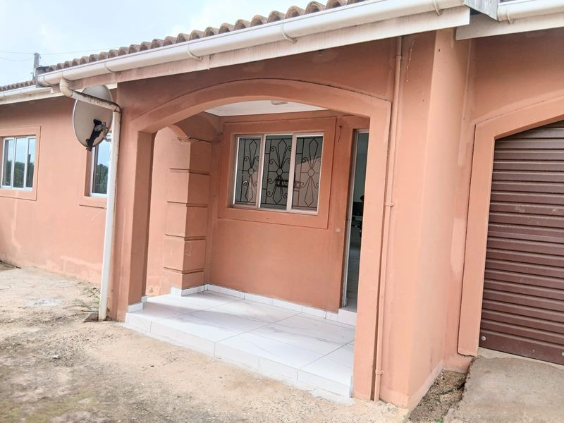 Front elevation of a cottage featuring a covered tiled porch, security-barred windows, and an integrated garage with a roller door.
