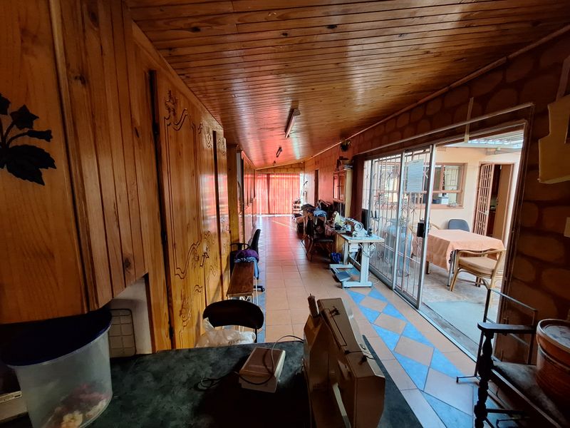 Enclosed patio area featuring timber ceiling, built-in cabinetry, and sliding glass doors leading to an outdoor space.