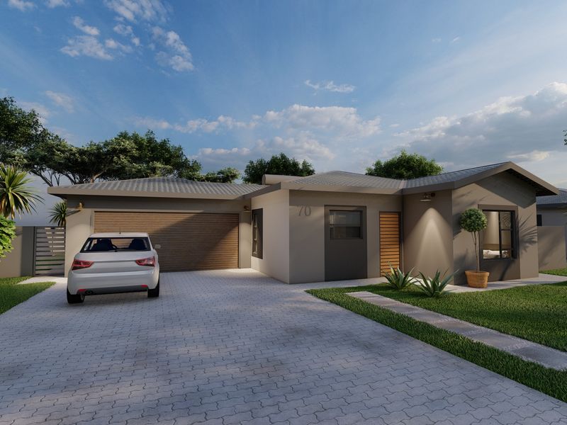 Modern single-story residential home featuring a paved driveway, integrated garage, and well-maintained front garden.