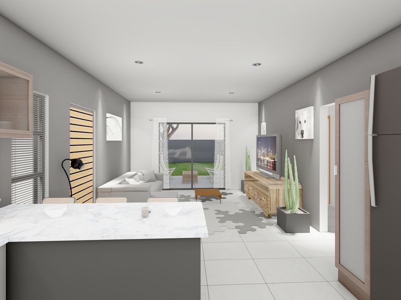 Modern open-plan living area featuring a kitchen island with marble-look countertop, tiled flooring, and sliding glass doors leading to the rear garden.