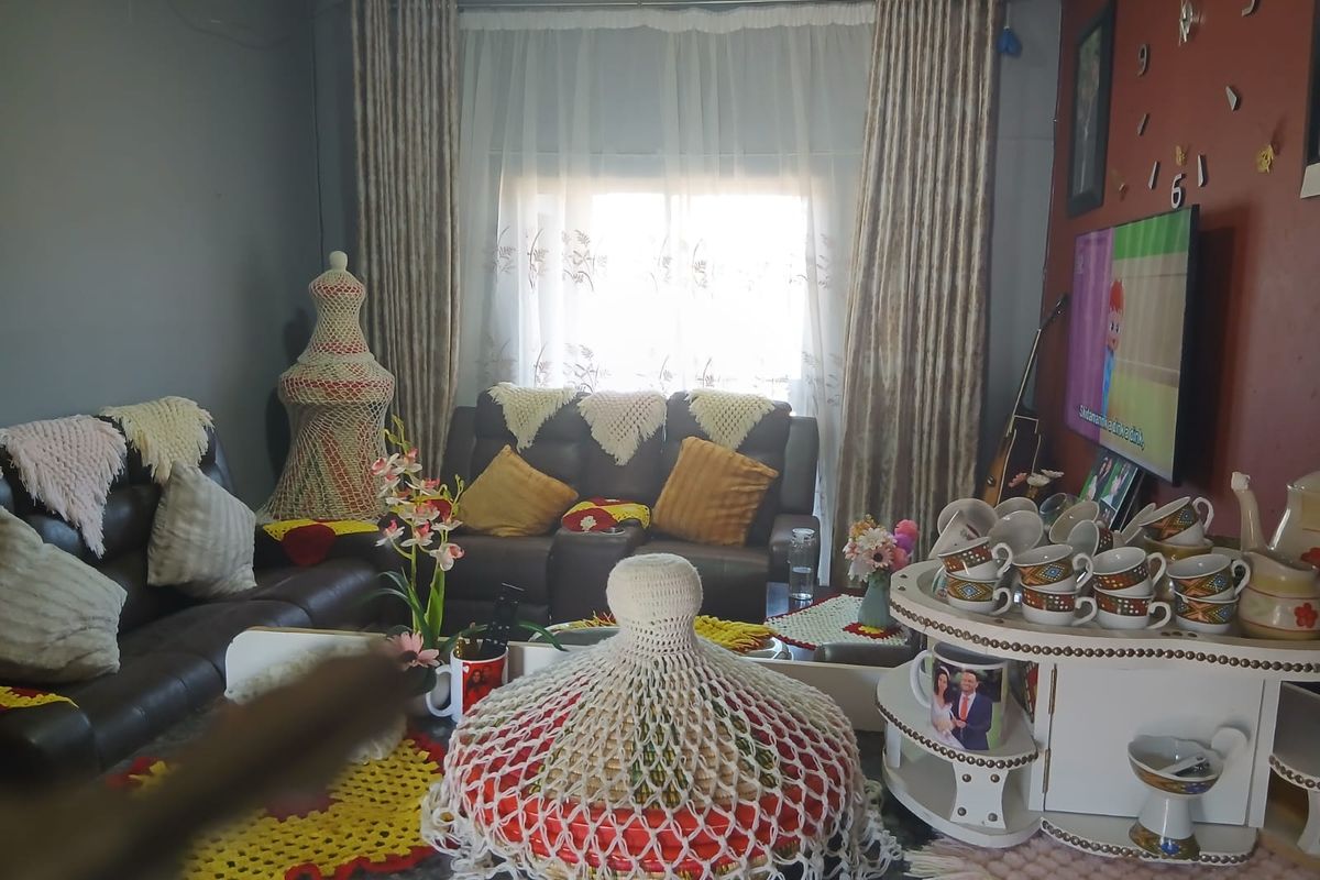 A living room area featuring a sliding glass door with curtains, providing natural light to the space.