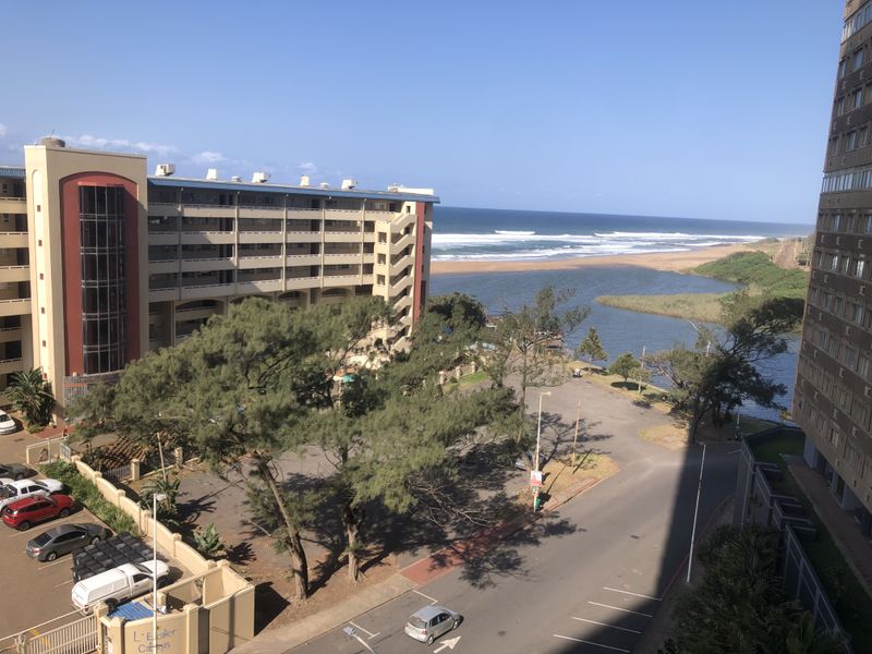 Elevated view overlooking the coastal landscape, river estuary, and surrounding apartment complex infrastructure.