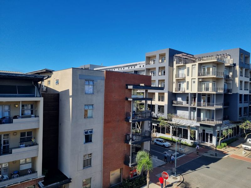 An elevated view of the surrounding apartment complex and street level, showcasing the building architecture and urban neighborhood setting.