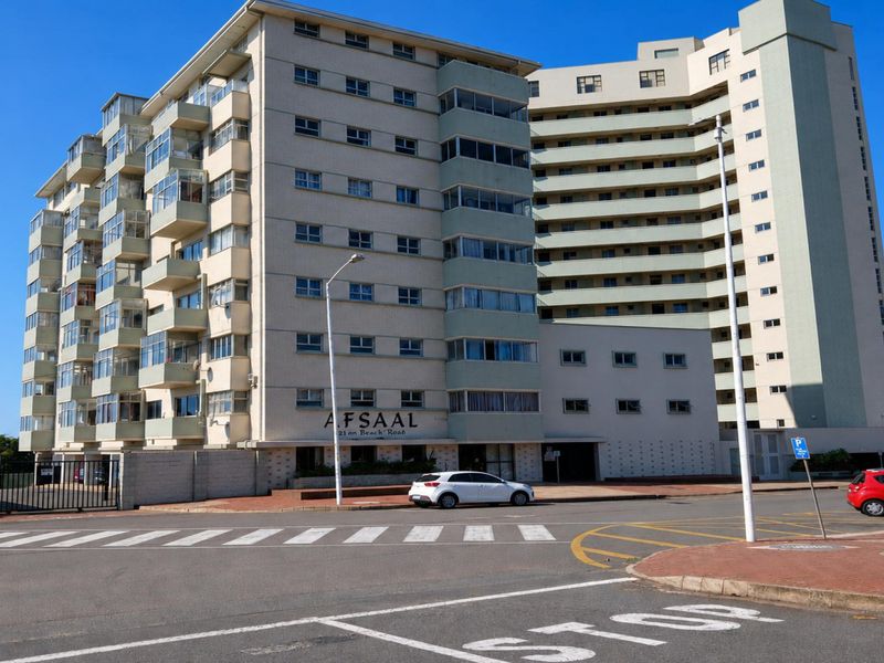Exterior view of the Afsaal apartment building, featuring a multi-story concrete facade with enclosed balconies and street-level access.