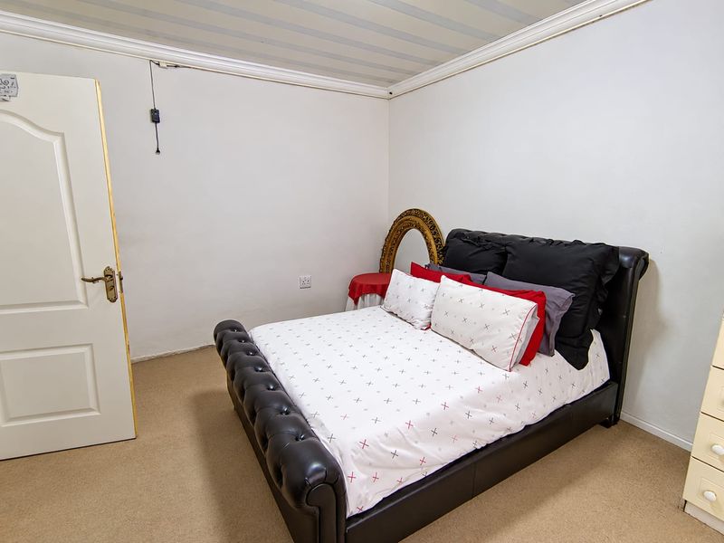 A bedroom featuring carpeted flooring and coved ceiling details, requiring minor cosmetic updates to improve the overall finish.