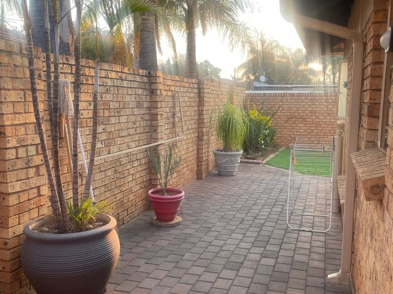 A private rear courtyard featuring paved flooring and a high brick boundary wall, providing a secure and low-maintenance outdoor space.