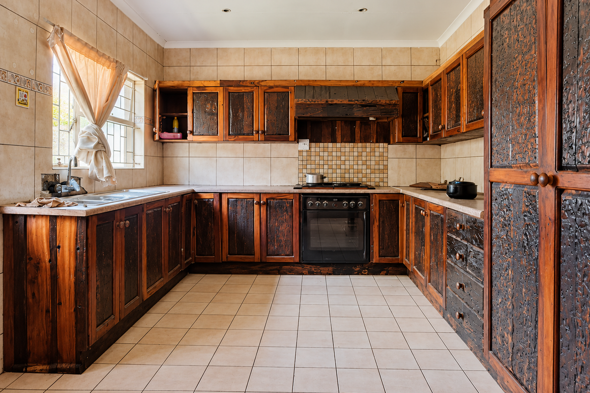 A functional kitchen featuring extensive built-in wooden cabinetry, tiled flooring, a built-in oven, and a double sink with a tiled backsplash.