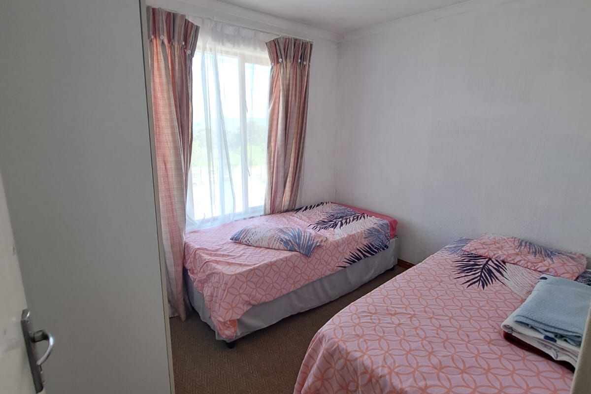 A functional bedroom featuring carpeted flooring and a built-in wardrobe, providing a comfortable and practical living space.