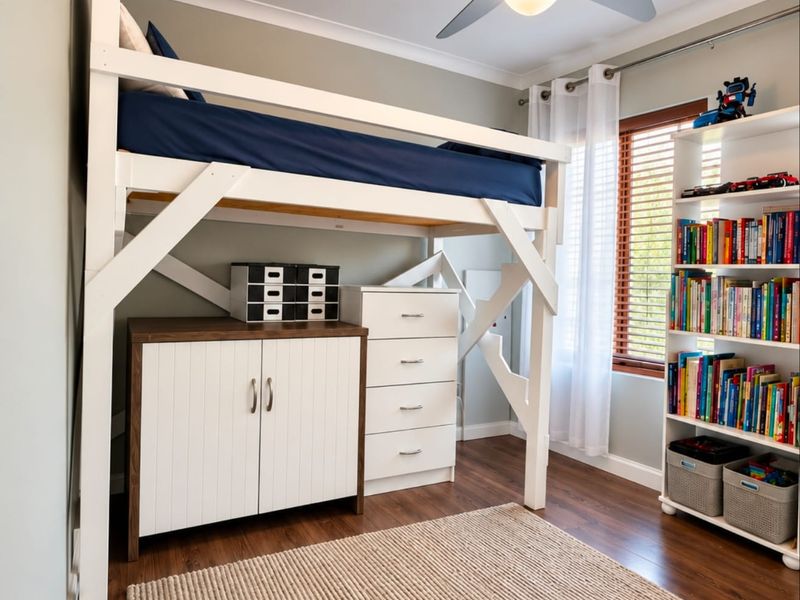 A well-maintained bedroom featuring laminate flooring, a modern ceiling fan, and timber venetian blinds, offering a clean and functional living space.
