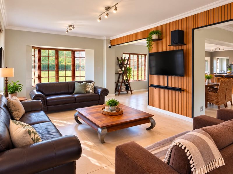 Spacious living room featuring a modern timber slat feature wall, tiled flooring, and large bay windows that provide ample natural light.
