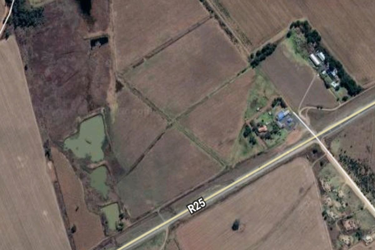 An aerial satellite view of the farm property showing surrounding fields, access roads, and landscape features.