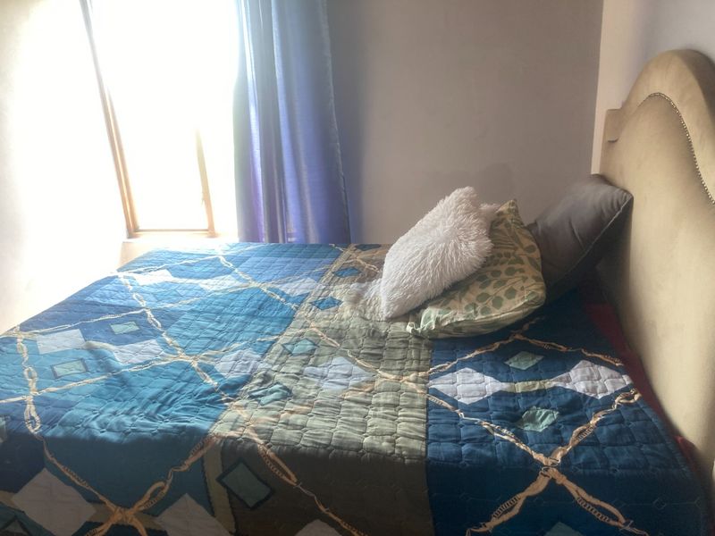 A bedroom featuring a window with natural light, providing a functional space for rest.