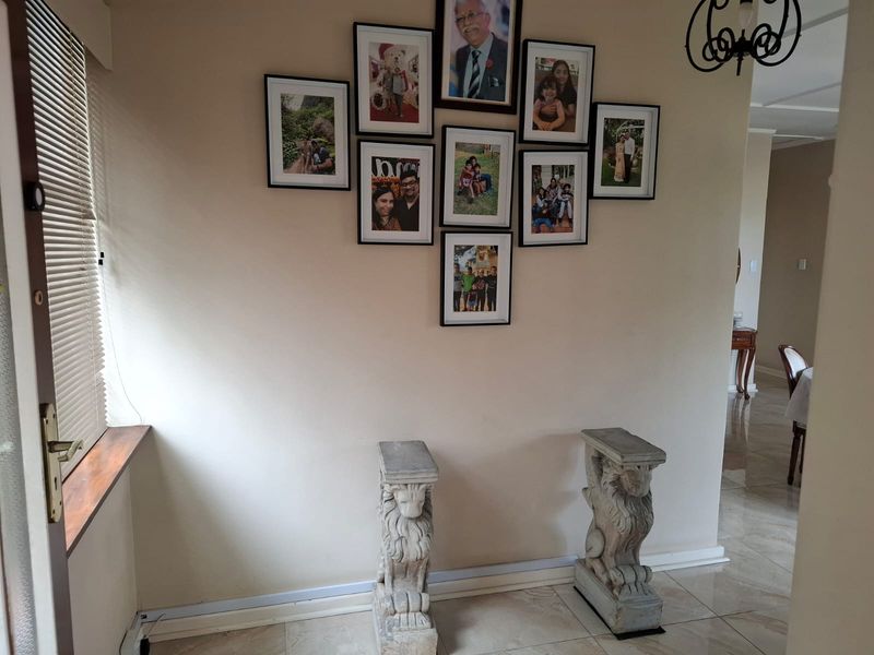A bright entrance area featuring tiled flooring and venetian blinds, providing a welcoming transition into the home.