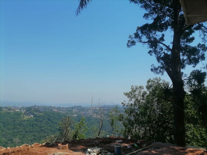 An elevated outdoor vantage point offering expansive panoramic views over the surrounding landscape and valley.