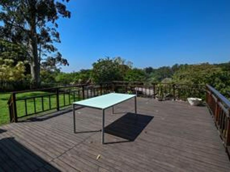 Spacious elevated timber deck offering expansive views of the surrounding garden and natural landscape.