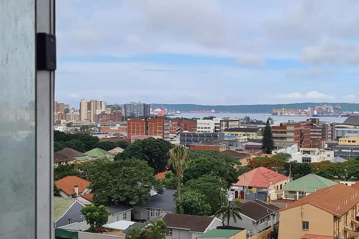 Elevated urban and coastal view overlooking the surrounding residential neighborhood and city skyline.
