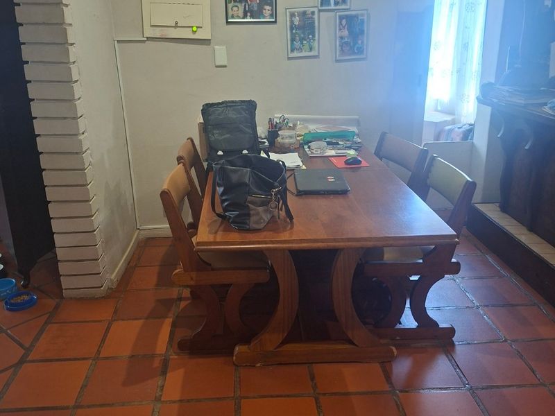 Dining area featuring traditional terracotta floor tiles and a distinctive brick archway, providing a rustic foundation for the space.