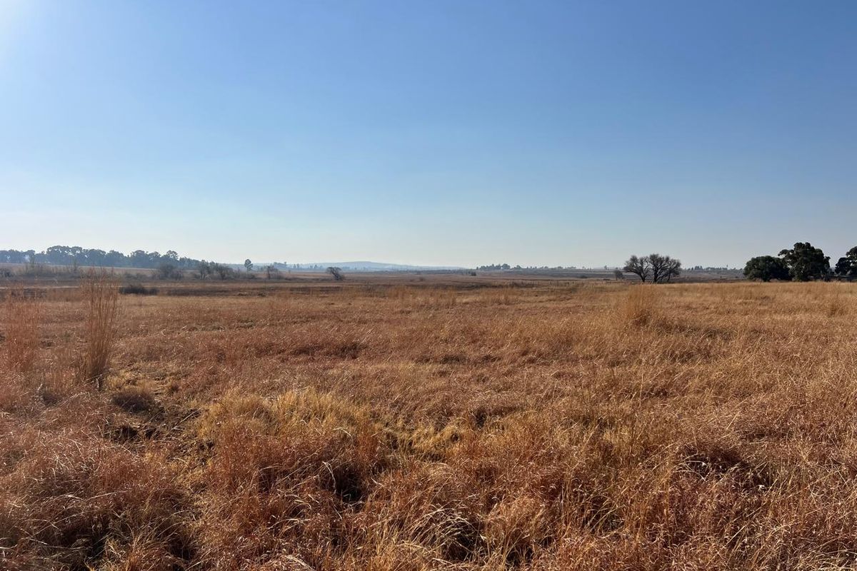 Expansive open landscape view showcasing the natural rural terrain and open fields of the farm property.