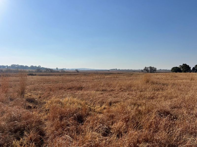 Expansive open landscape view showcasing the natural rural terrain and open fields of the farm property.